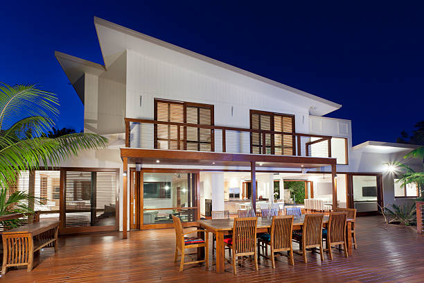 Contemporary two story home with deck at dusk stock photo