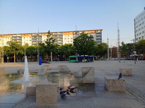 Varna, Bulgaria - June 4, 2011: A fountain sitting in the middle of a commercial district in Varna, Bulgaria. People can be seen walking around in the background.