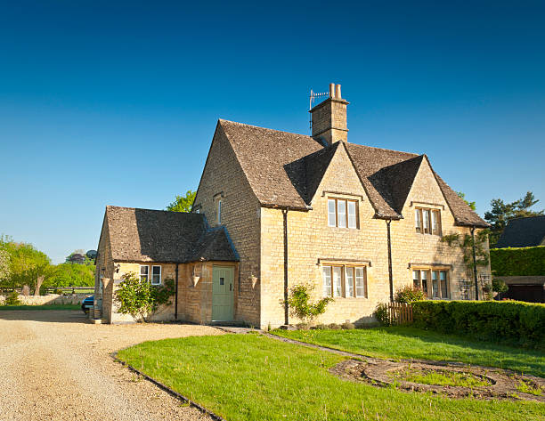 Idyllic home Traditional family home with well manicured garden bathed in warm early sunlight. gloucestershire stock pictures, royalty-free photos & images