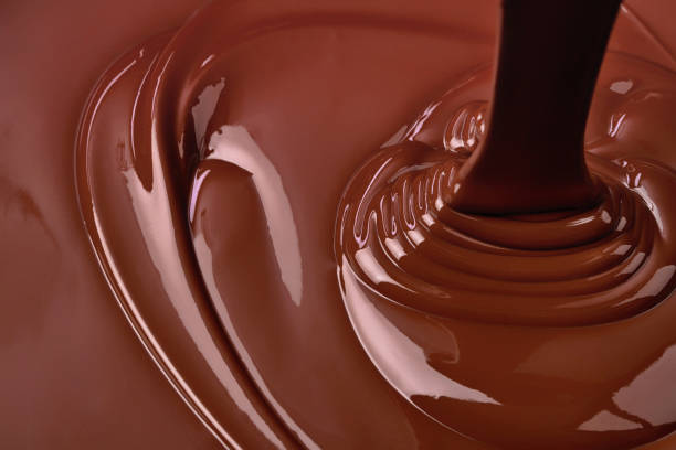 istock pouring hot chocolate, sweet dessert. liquid chocolate background 1639300174