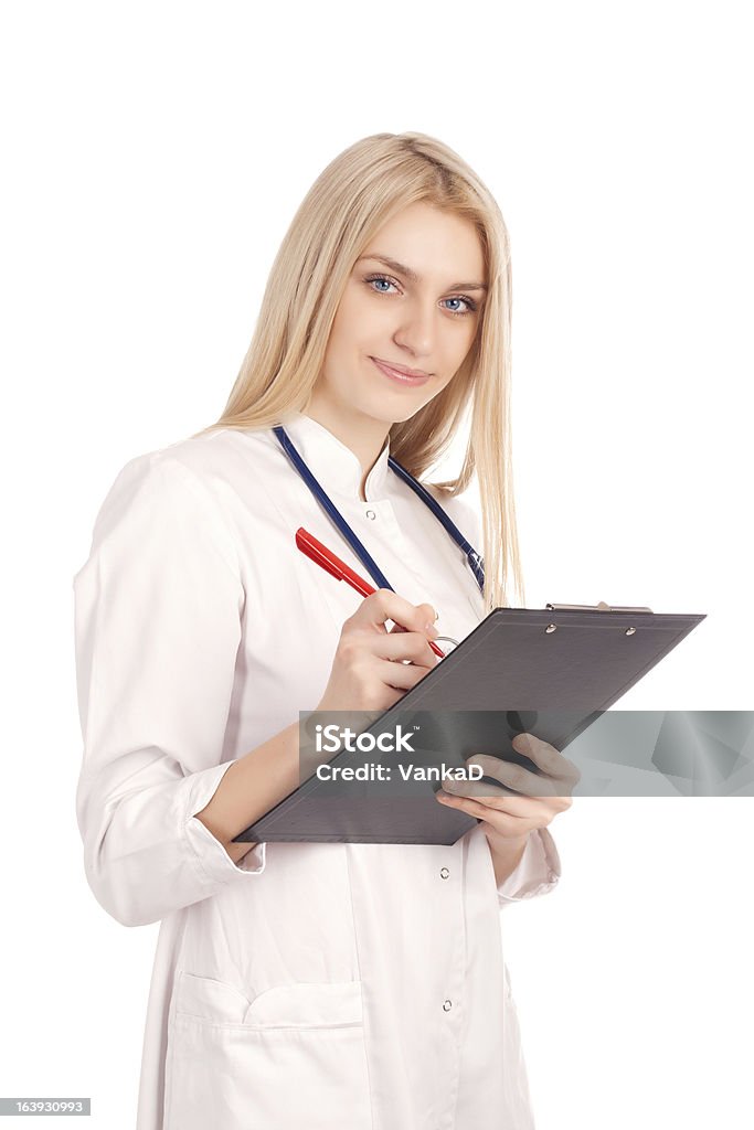 Jovem médico escrevendo na área de transferência - Foto de stock de Adulto royalty-free