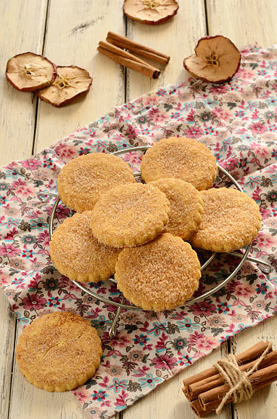 istock Apple cookies powdered with sugar and cinnamon on wooden background 163931446