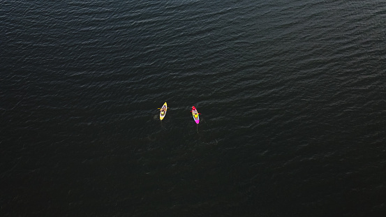 Aerial view of people kayaking on Ocean.