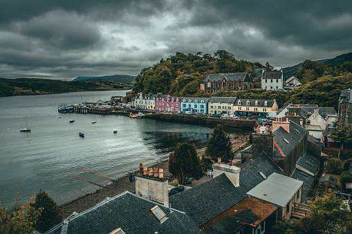 The view of the colorful houses in the harbor area in Portree in the Isle of Skye in overcast weather