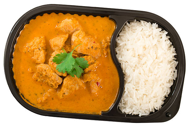Takeaway Curry Takeaway Curry - Chicken curry with coconut milk and plain rice in a plastic container isolated on white. convenience food photos stock pictures, royalty-free photos & images