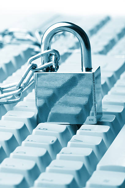 Computer  keyboard secured with chain and padlock stock photo