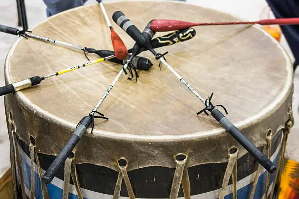 Indian drum and drum sticks placed in  a symbolic manner after the drummers complete their song at a Native American pow-wow.