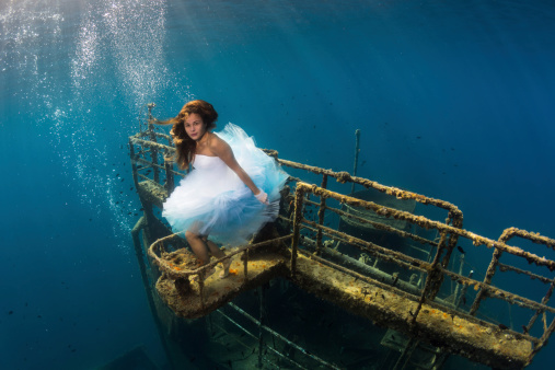 Young woman on the wreck and under the water.