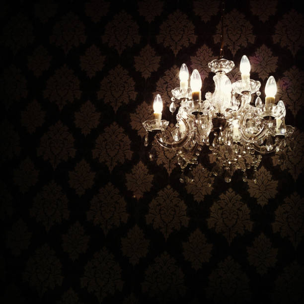 istock Glowing Chandelier Hanging in Darkness 163943488
