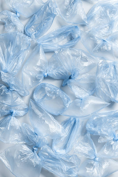 istock Plastic free environment protection concept. Empty used plastic bags as background. Top view many blue disposable polyethylene packets, monochrome texture background. Plastic bag free day 1639439119