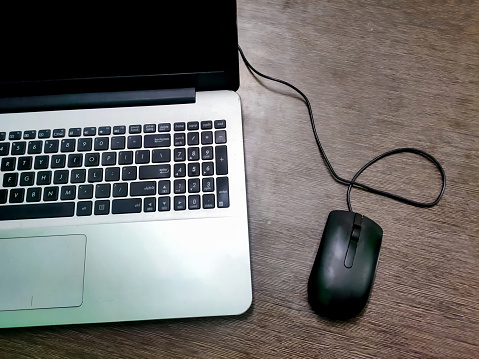 A Laptop keyboard, computer mouse. Working atmosphere on the table. Freelance. Business.