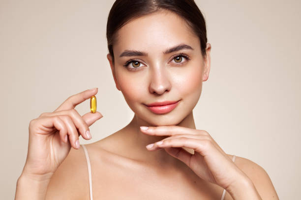 istock Beautiful Girl With Pill With Cod Liver Oil Omega-3 1639470107