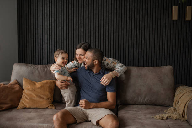 Modern fatherhood lifestyle at home for diverse family stock photo