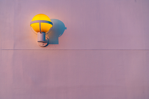 Outdoor wall lamp in white background at dusk