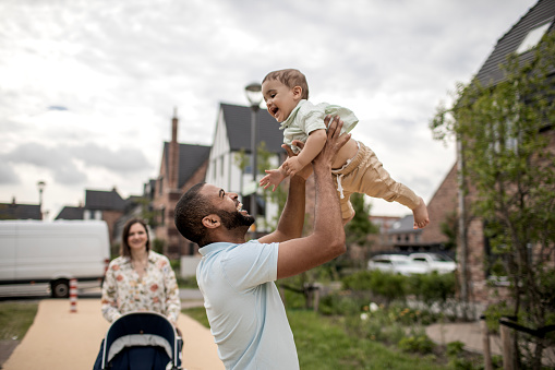 Modern fatherhood outdoor lifestyle in the neighbourhood for diverse family