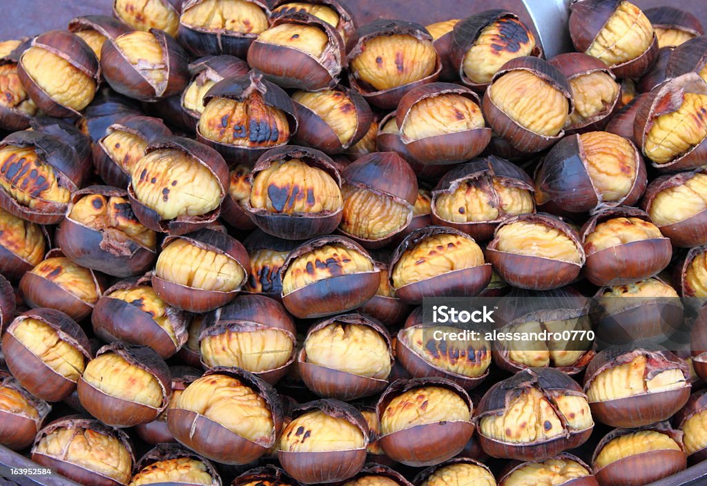 Grilled chestnuts Grilled chestnuts for sale in a market stall Autumn Stock Photo