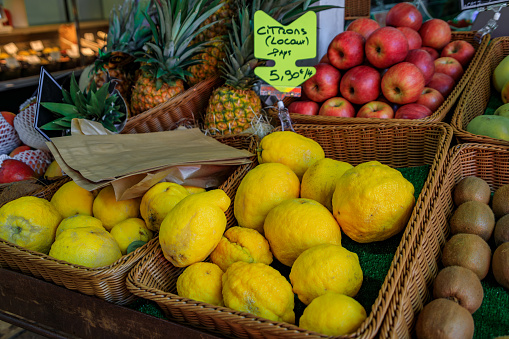 Ripe yellow lemons or citrons on a stand at a local farmers market in the Old Town, Vieille Ville in Menton, French Riviera, France