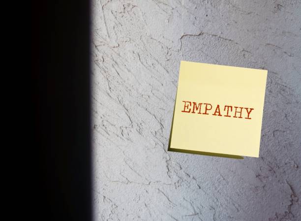 istock Grey rough copy space wall background with sticky note written EMPATHY, ability to understand others point of view or feelings ,see a problem from customers,team,co-worker perspective 1639567991