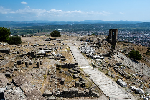 Bergama, Turkey - August 26, 2023:ACROPOLIS OF PERGAMON\nIn 2014, Bergama was included in the World Cultural Heritage List. Although Bergama has been subjected to invasions and destructions throughout its history, it has been continuously inhabited due to its strategic location and is one of the settlements that have never disappeared from the stage of history.  \n Local and foreign tourists visit here