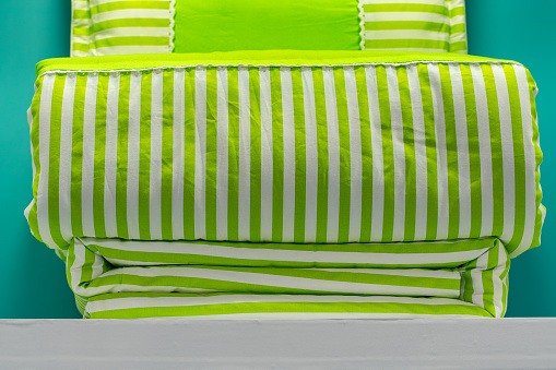 green striped quilt on bed