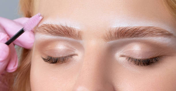 istock Blonde woman having permanent make-up tattoo on her eyebrows. Closeup beautician doing tattooing eyebrow.Professional makeup and cosmetology skin care. 1639601916