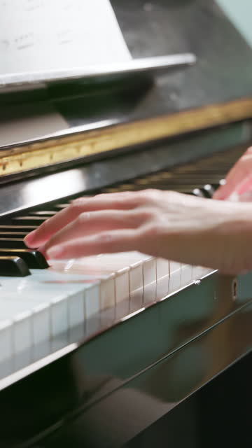 hands of woman play piano
