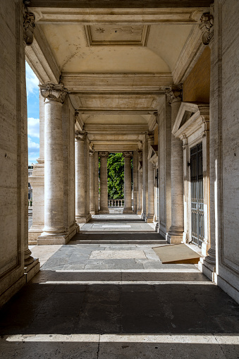 Rome, Italy, October 16 -- The neoclassical colonnade of the Palazzo Novo in Piazza del Campidoglio or Roman Capitol, in the historic heart of Rome. The neoclassical colonnade of the Palazzo Novo in Piazza del Campidoglio or Roman Capitol, in the historic heart of Rome. Initially designed by Michelangelo Buonarroti, like the rest of the Capitoline square, this palace was built in the 17th century by Girolamo Rainaldi and finished by his son Carlo Rainaldi in 1663. In 1980 the historic center of Rome was declared a World Heritage Site by Unesco. Image in high definition format.