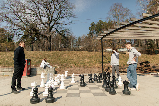 Mega chessboard outdorrs. Chess game.