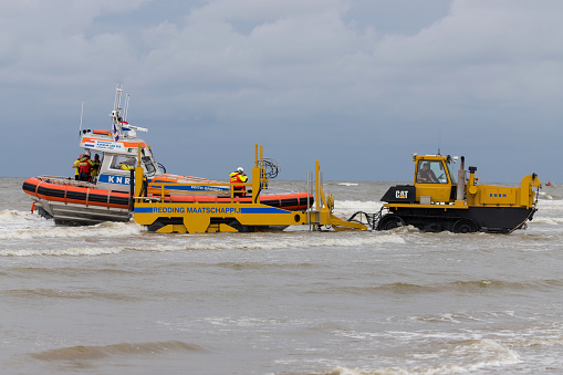 Katwijk aan Zee, Netherlands - July 6, 2019: KNRM lifeboat Edith Grondel being pulled of the North Sea. KNRM is the voluntary organization in the Netherlands tasked with saving lives at sea.