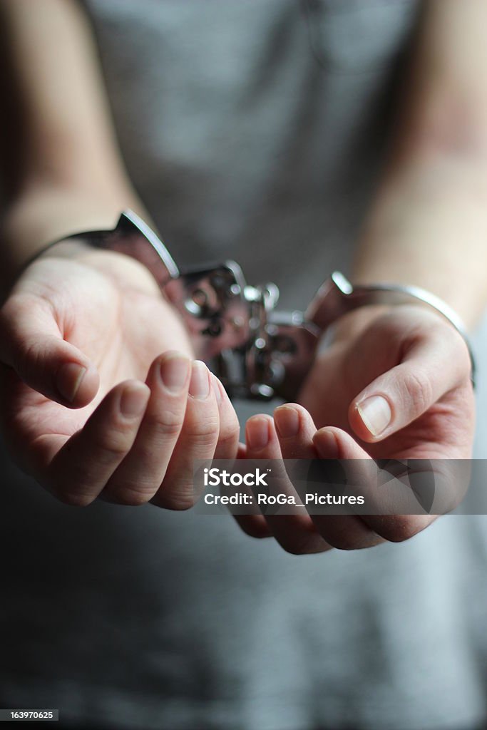 handcuffed woman bagging for freedom Please release me! Black & White close-up of a woman bagging for freedom. Adult Stock Photo