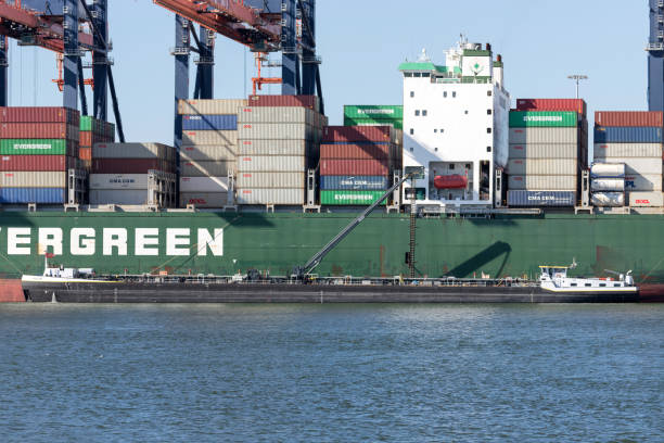 Maasvlakte, Netherlands - July 1, 2019: inland tanker Aquilon refueling container ship Ever Lifting at the Euromax Terminal