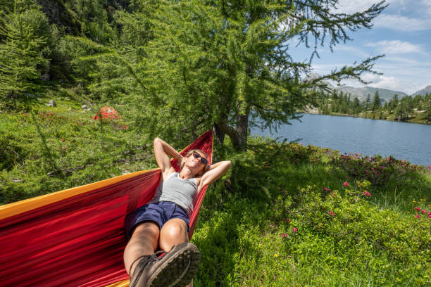 Female hiker relaxer on hammock in nature