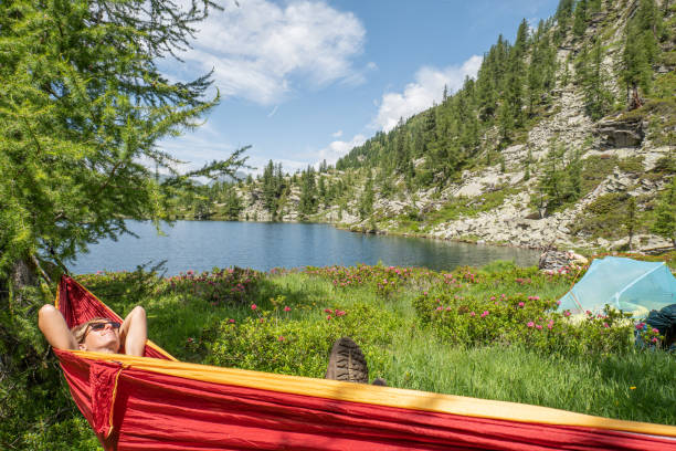 istock Female hiker relaxer on hammock in nature 1639734829