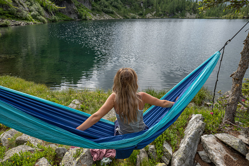 Woman on hammock by the lake