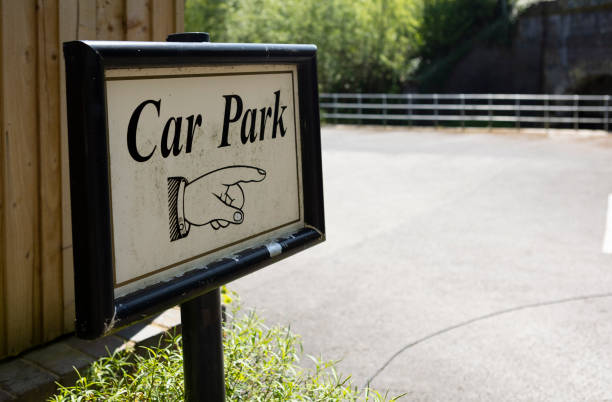 car parking sign with hand pointing