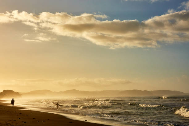 Scenic view of beach against dramatic sky during sunrise