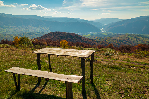 Wooden bench and table on the mountain trail. Rest with a scenic view