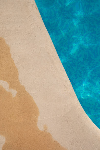Edge of an outdoor swimming pool in summer sunlight, Spain