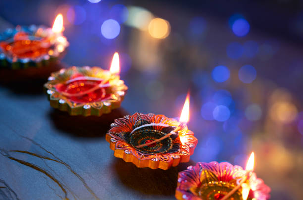 istock Colorful clay diya lamps lit during diwali celebration 1639836975
