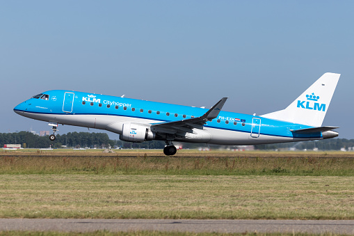 Vijfhuizen, Netherlands - June 28, 2019: Dutch KLM Cityhopper Embraer ERJ-175 with registration PH-EXH taking off runway 36L (Polderbaan) of Amsterdam Airport Schiphol.