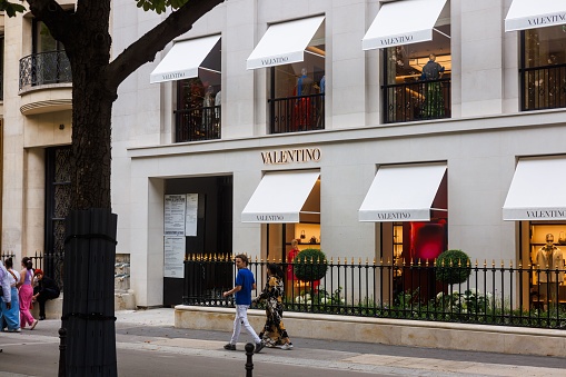 Paris, France – June 26, 2023: A Valentino store in Paris with people walking nearby