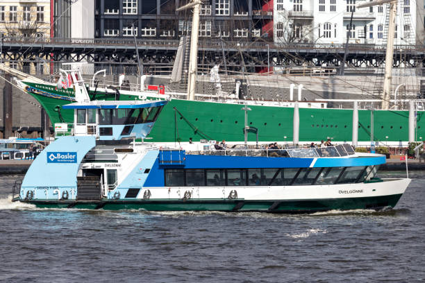 typical flat-iron-shaped HADAG ferry ‘Övelgönne’ in front of the St. Pauli Piers Hamburg, Germany - April 9, 2019: Typical flat-iron-shaped HADAG ferry ‘Övelgönne’ in front of the St. Pauli Piers. The HADAG owns and operates passenger ferries across the Elbe River. övelgönne stock pictures, royalty-free photos & images