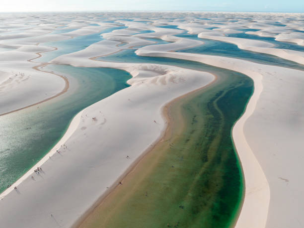 Aerial view of Lencois Maranhenses. White sand dunes with pools of fresh and transparent water. Desert. Brazil Aerial view of Lencois Maranhenses. White sand dunes with pools of fresh and transparent water. Desert. Barreirinhas. Maranhao State National Park. Brazil brazil desert maranhao state national park stock pictures, royalty-free photos & images