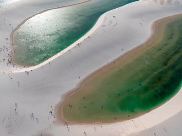 Aerial view of Lencois Maranhenses. White sand dunes with pools of fresh and transparent water. Desert. Brazil Aerial view of Lencois Maranhenses. White sand dunes with pools of fresh and transparent water. Desert. Barreirinhas. Maranhao State National Park. Brazil brazil desert maranhao state national park stock pictures, royalty-free photos & images