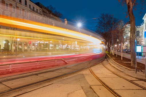 Tram moving on a street at dusk - Vienna, Austria