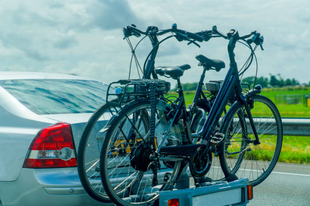 istock Car transports bicycles on a rack on highway 1639985271