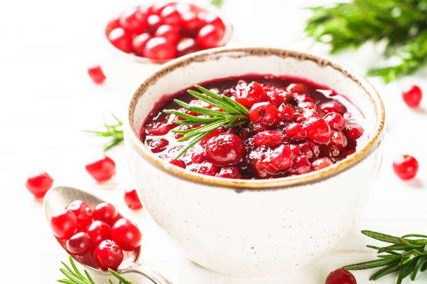 istock Cranberry sauce in a bowl on white table. 1639989587