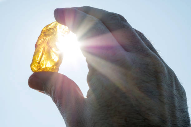 istock male hand holds amber against the sun 1640014864