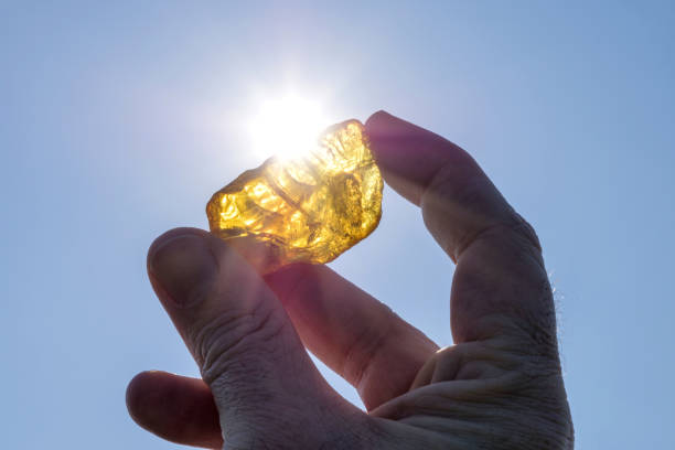 istock male hand holds amber against the sun 1640015068