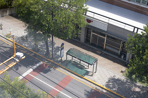 Bus stop with bench in city. Empty bus stop.